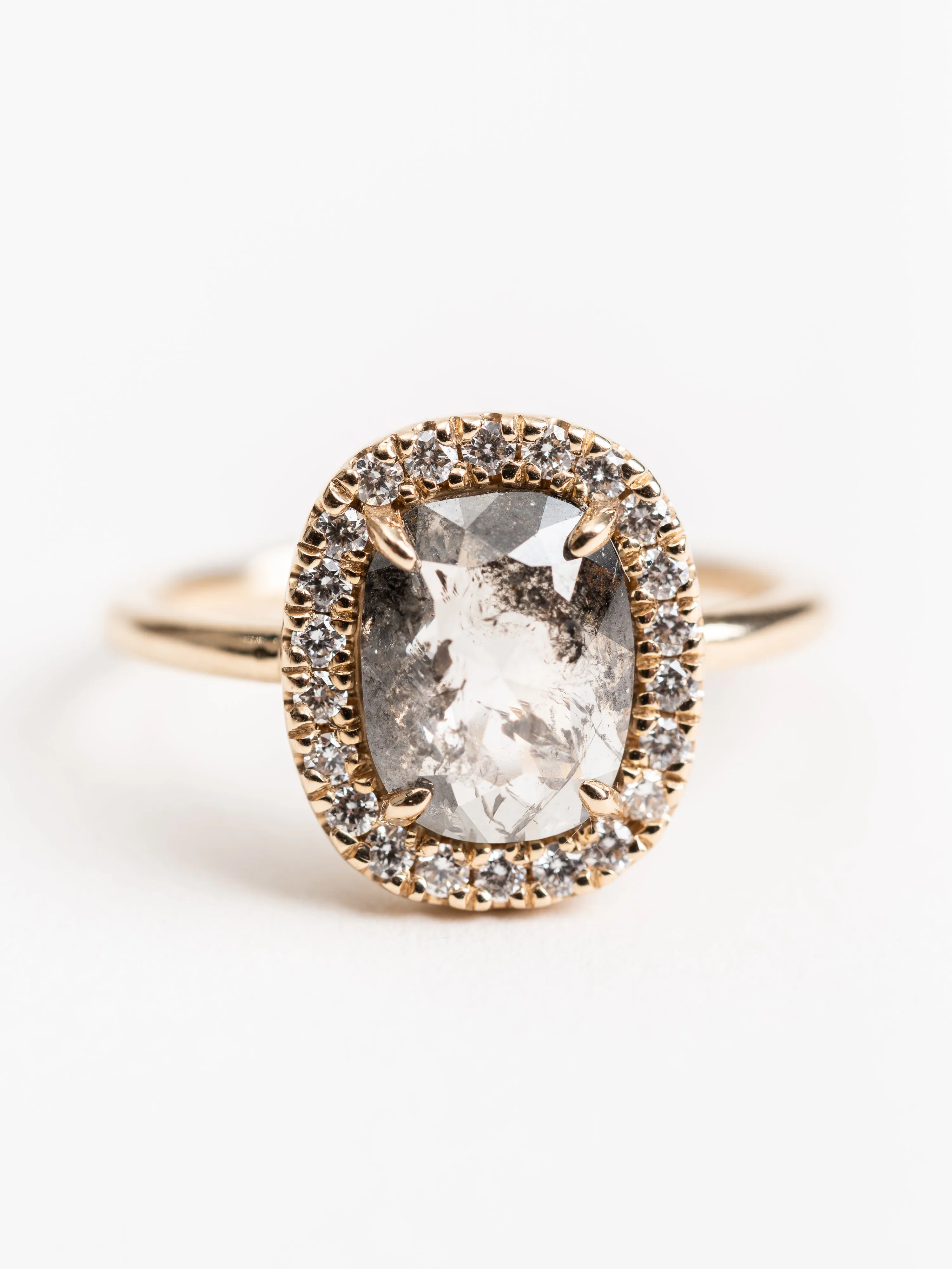 black oval diamond ring with halo setting
